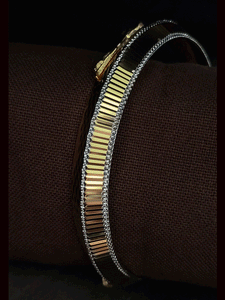 Lines on one side and Jaguar motif wavy design  on other side of rhodium and gold plated kada