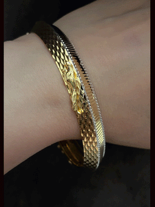 Lines on one side and Jaguar motif wavy design  on other side of rhodium and gold plated kada