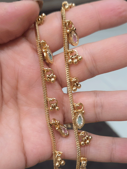 Chain anklets with leaf shaped coloured stones hanging tukdies and ghunghru hangings