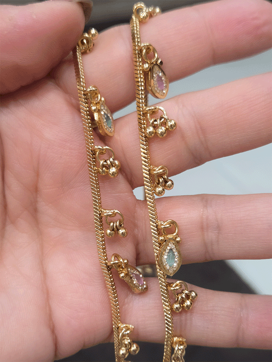 Chain anklets with leaf shaped coloured stones hanging tukdies and ghunghru hangings