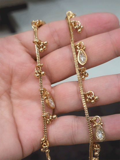 Chain anklets with leaf shaped coloured stones hanging tukdies and ghunghru hangings