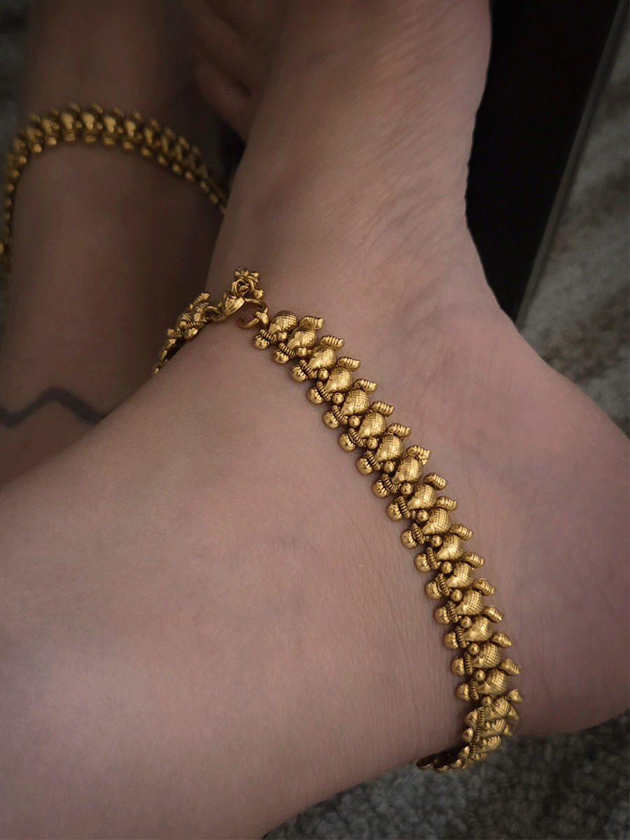Gold bead top with leaf attached at the bottom of leaf shaped gold bead chain anklets