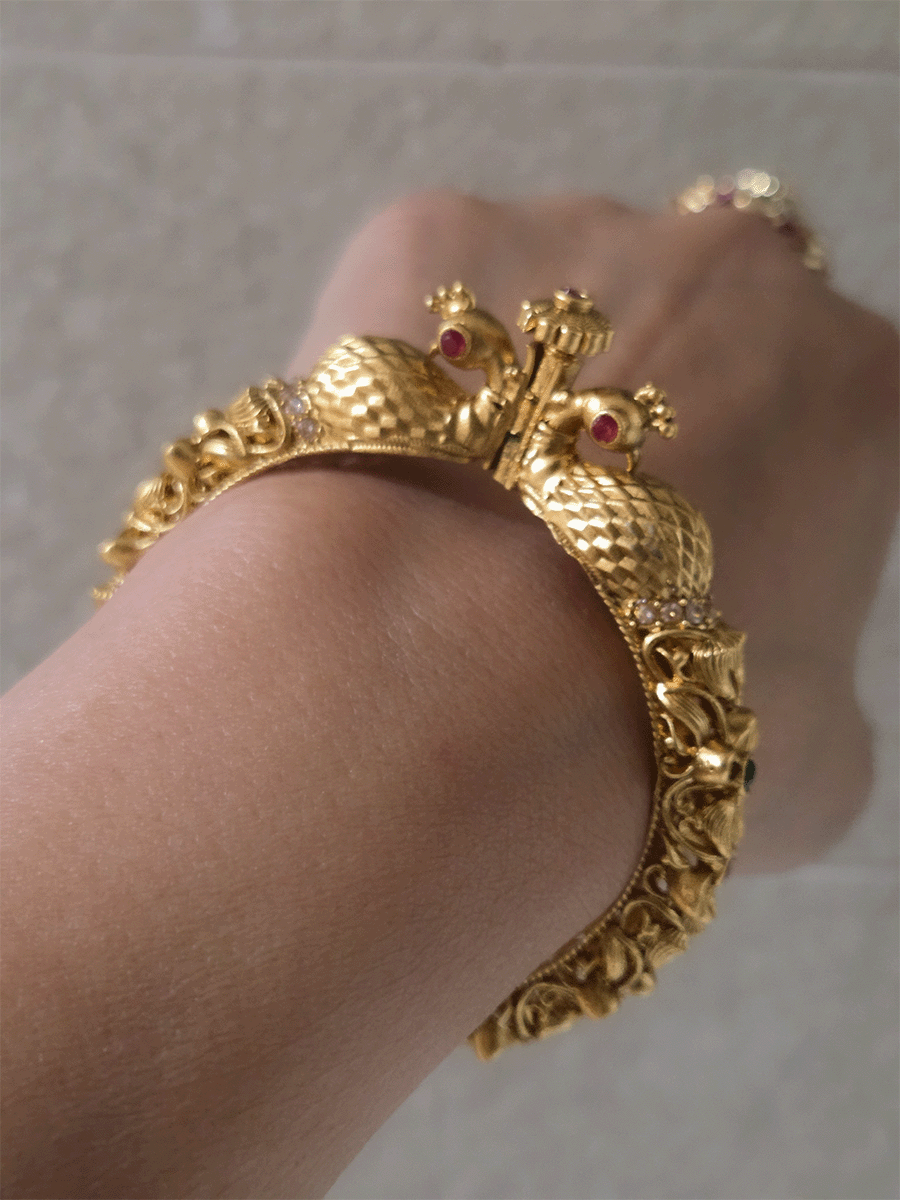 Intricate side flower design with ruby and green stones single peacock mouth openable kada