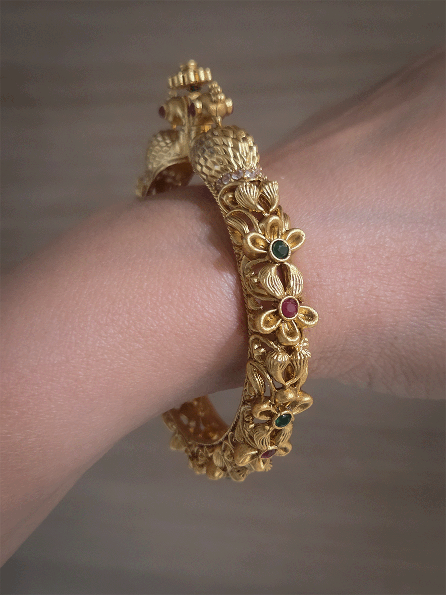 Intricate side flower design with ruby and green stones single peacock mouth openable kada
