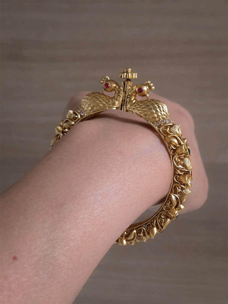 Intricate side flower design with ruby and green stones single peacock mouth openable kada