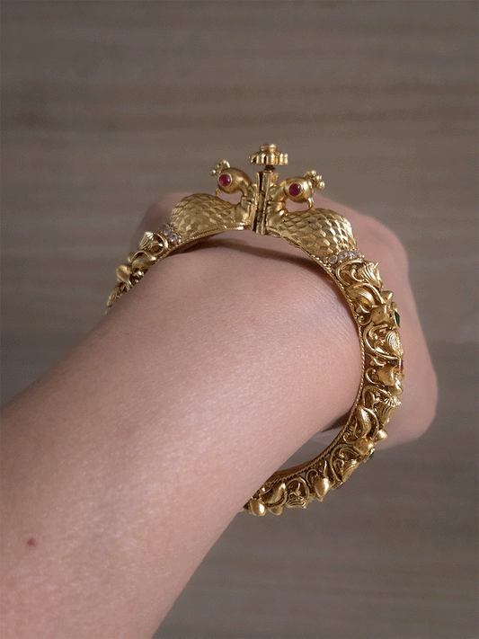 Intricate side flower design with ruby and green stones single peacock mouth openable kada