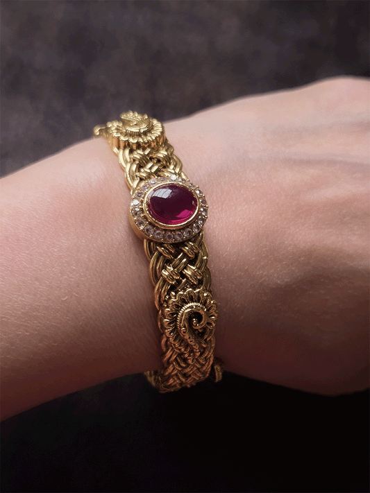 Single openable braid design kada with oval ruby stone center and peacock design on sides