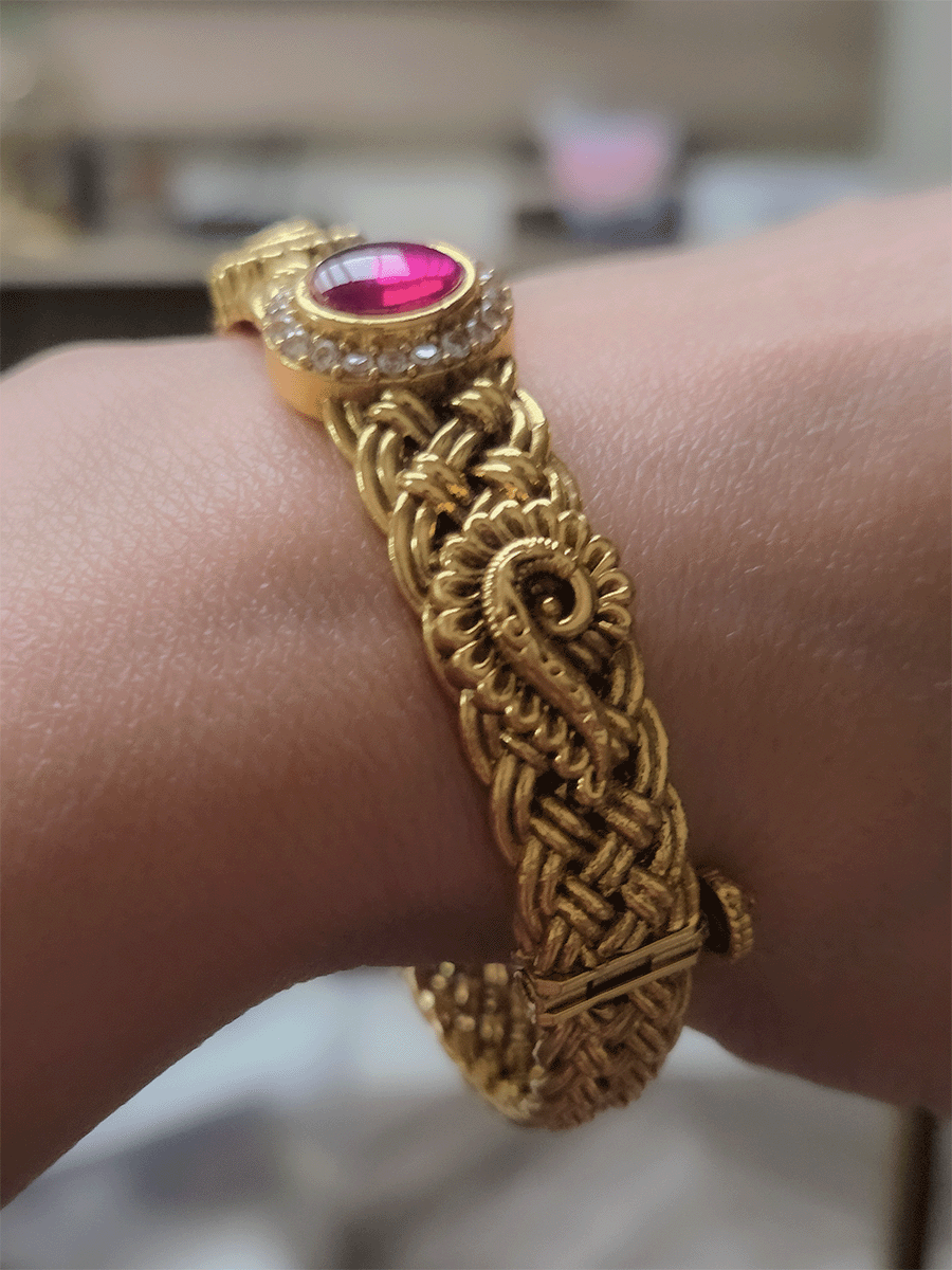 Single openable braid design kada with oval ruby stone center and peacock design on sides