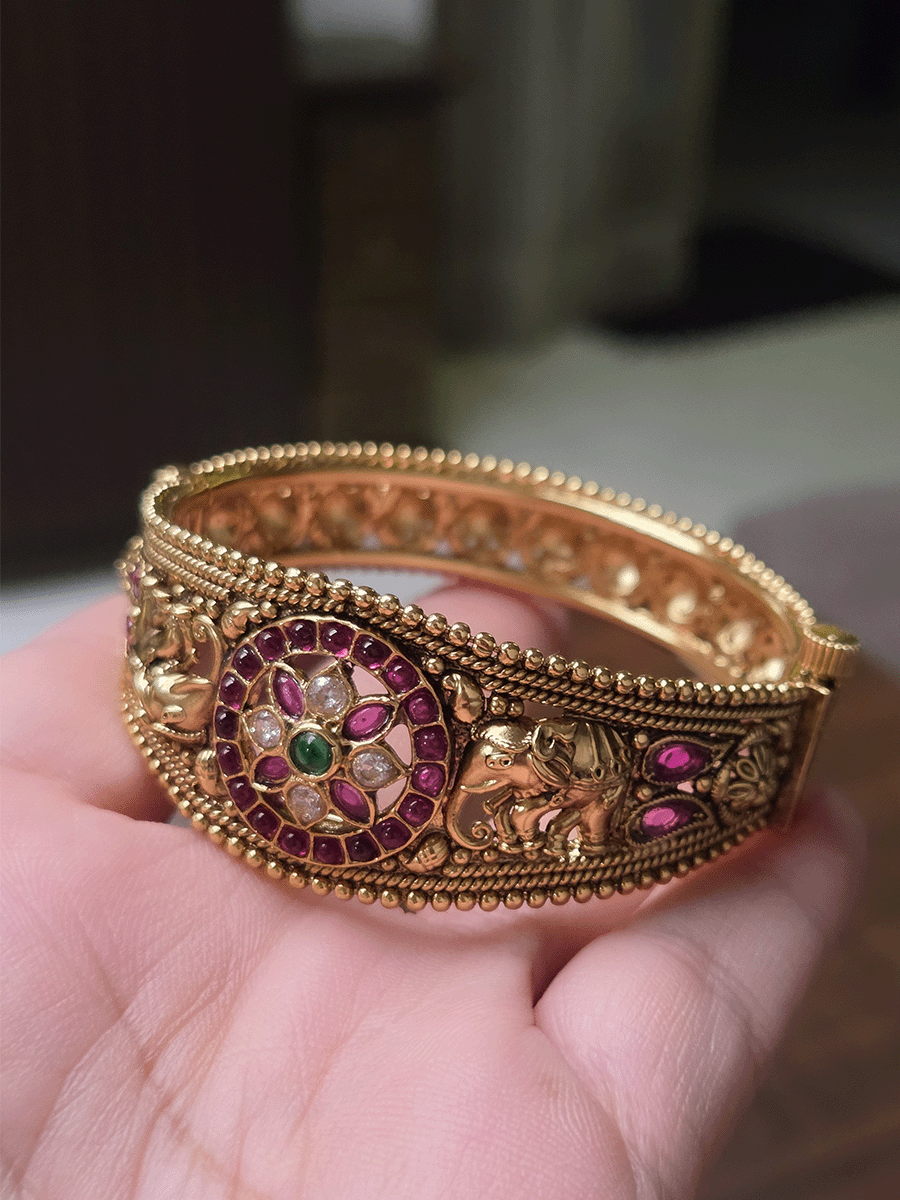 Single openable kada with polki,ruby and green stone circular design in center with elephants on both sides
