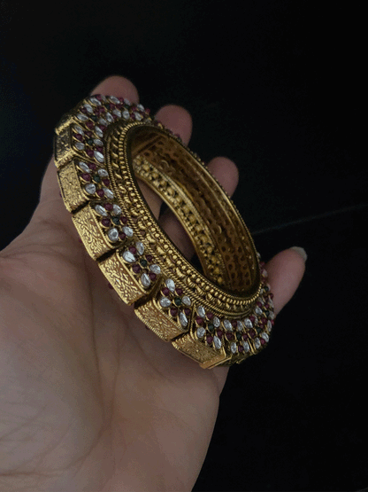 Set of two openable pacheli jadau gold top design kada's with ruby, green stones and kundan studded on sides