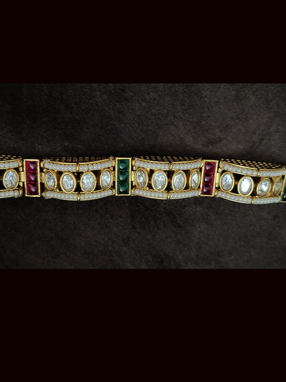 Single flexible openable kundan bracelet with cheed pirohi on sides and ruby green stones detailing