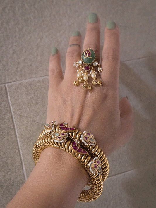 Set of two openable gold plated katas with peacock and three leaf ruby and aqua tukdies