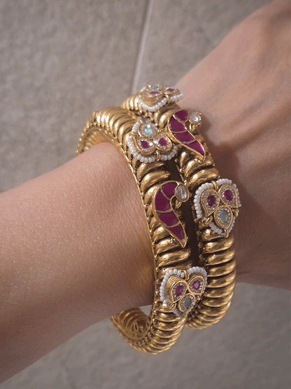 Set of two openable gold plated katas with peacock and three leaf ruby and aqua tukdies