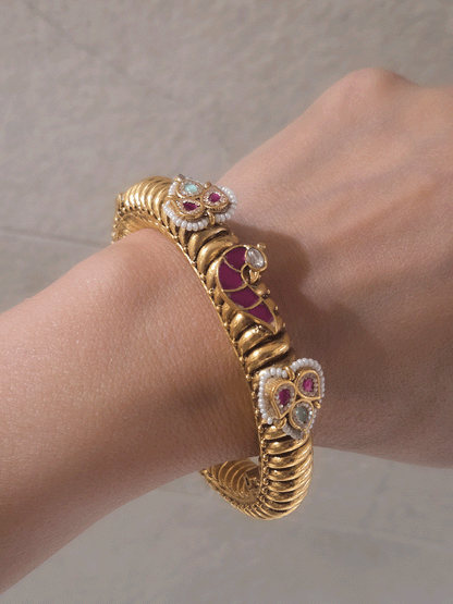 Set of two openable gold plated katas with peacock and three leaf ruby and aqua tukdies