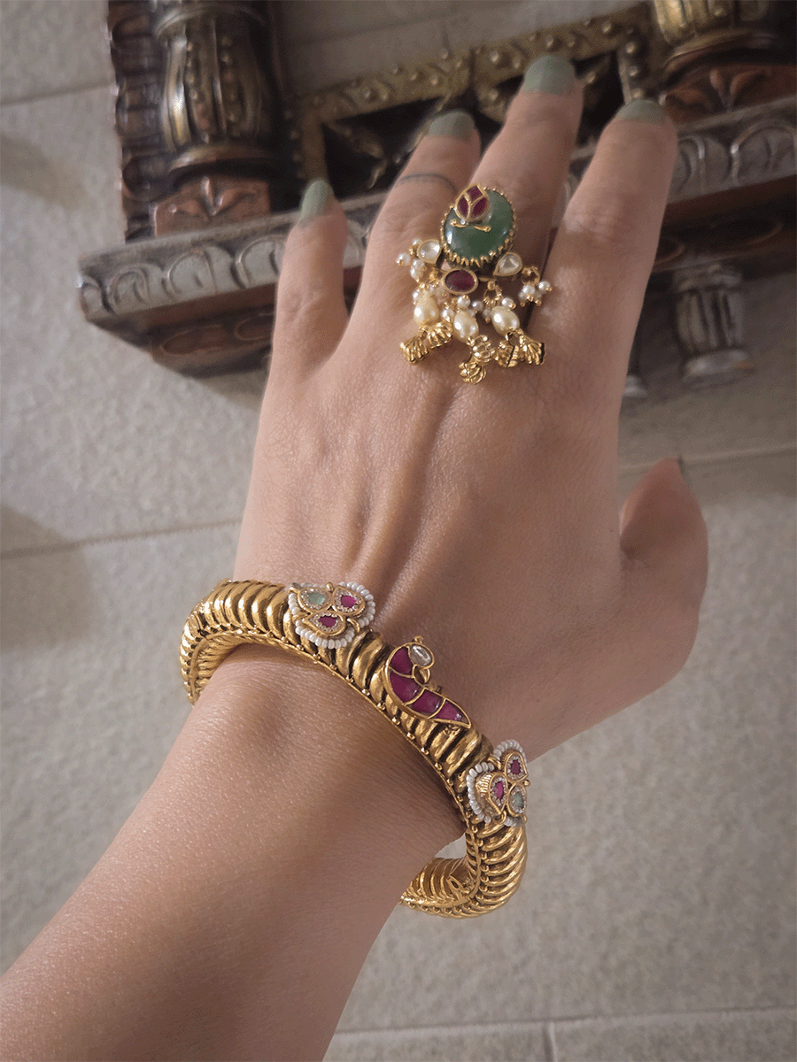 Set of two openable gold plated katas with peacock and three leaf ruby and aqua tukdies
