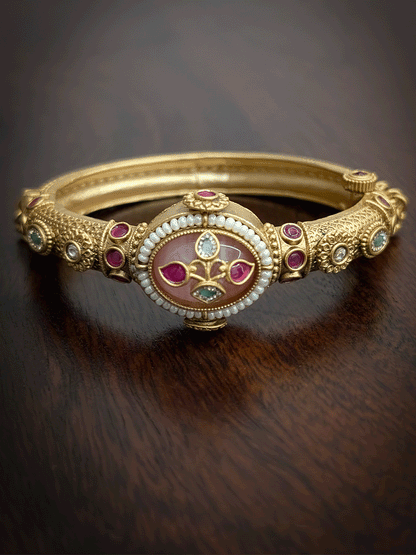 Oval coloured stone in center of single openable kada with kundan studded inlay work on stone and ghunghru hangings