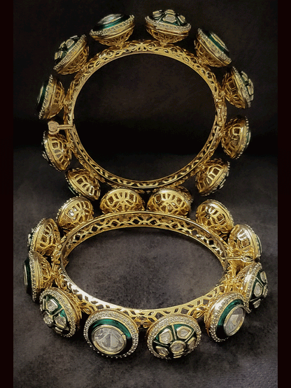Set of two openable green enamel uncut polki with zircon detailing pacheli's