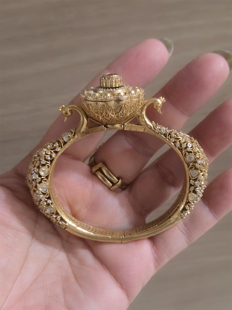 Single openable intricate carving with peacocks on sides moissanite kada with flower design in center
