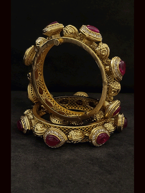 Set of two openable tear drop shaped ruby stones surrounded by zircons pacheli kada's with alternate shankh motif's