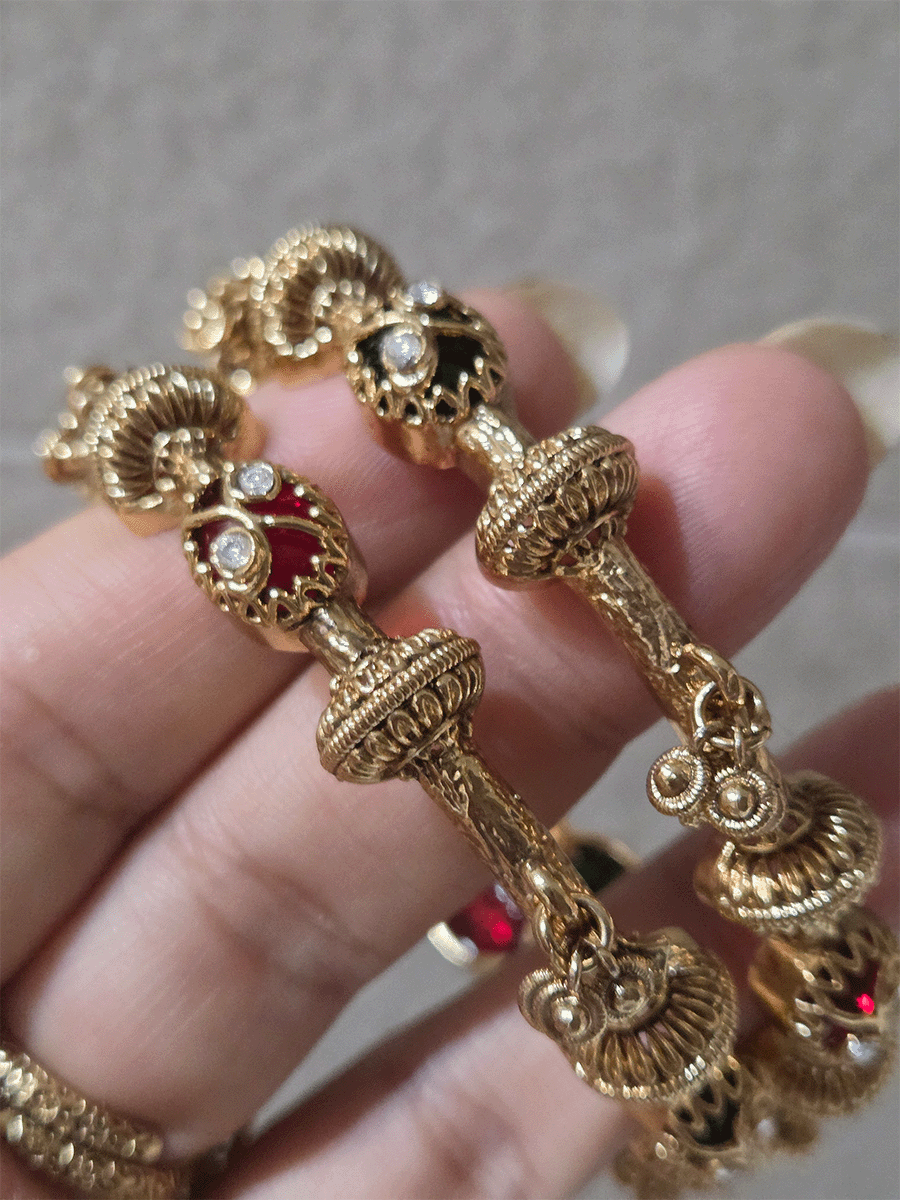 Set of two non openable ruby and green stones inlay work kadas with gold bead design