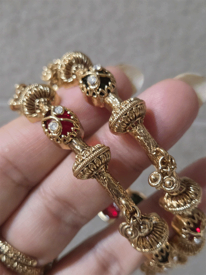 Set of two non openable ruby and green stones inlay work kadas with gold bead design