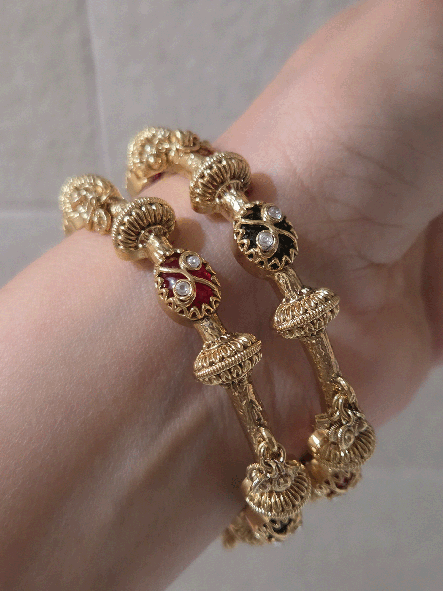 Set of two non openable ruby and green stones inlay work kadas with gold bead design