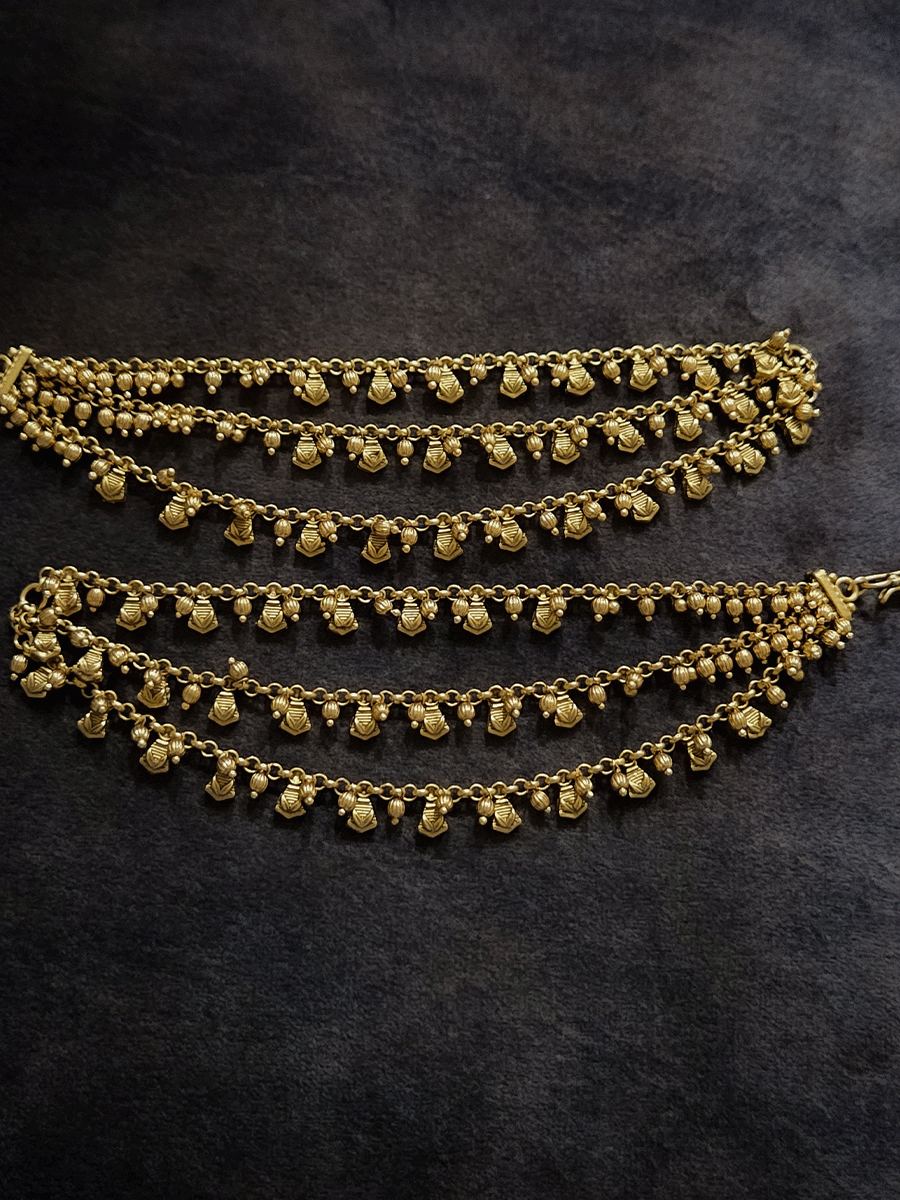 Golden tukdi with self leaf design and bead hanging three layer ear chains