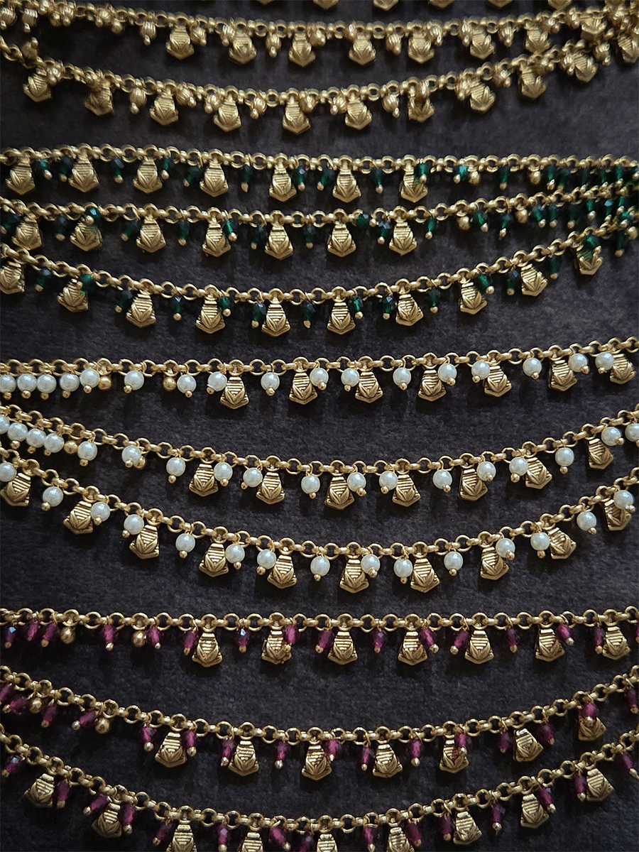 Golden tukdi with self leaf design and bead hanging three layer ear chains