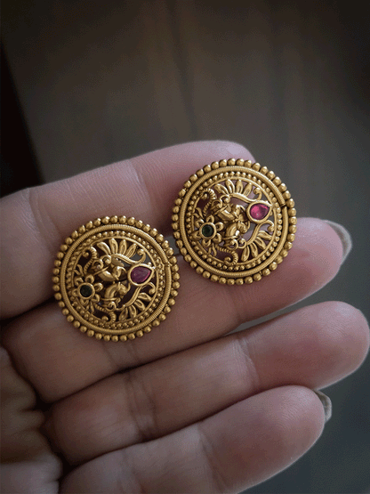 Circular flower with green stone at bottom of peacock design studs with tear shaped ruby stone