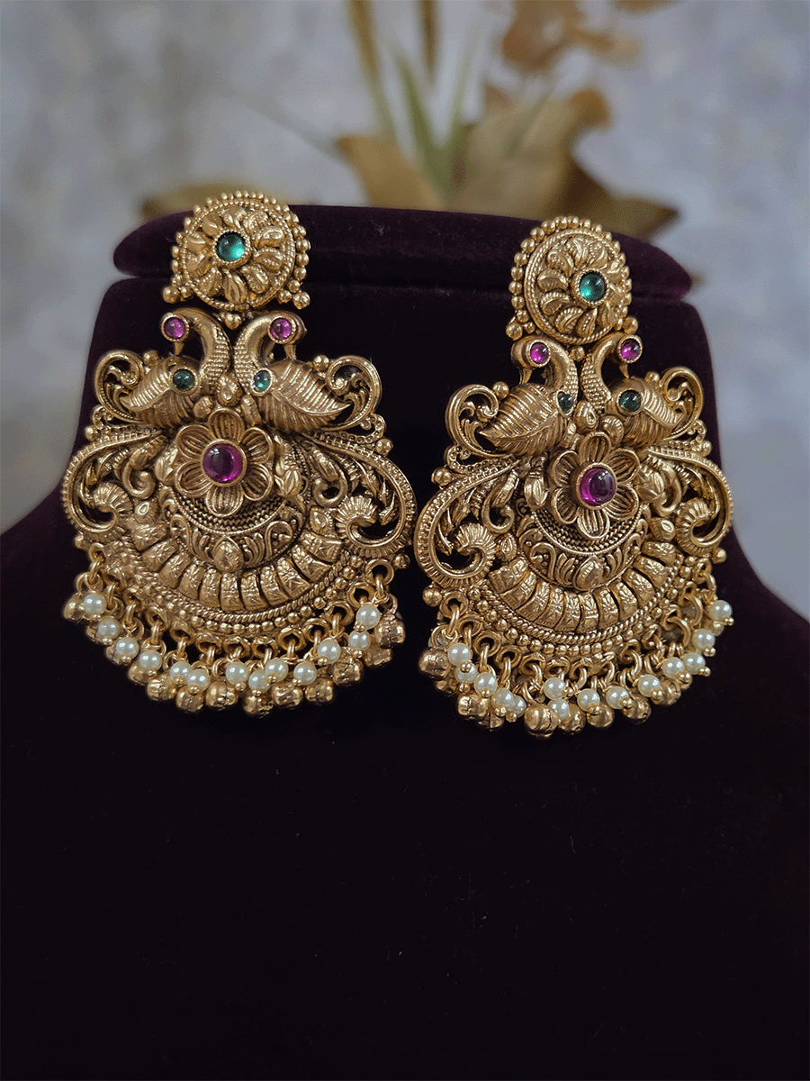 Circular ruby stone top with peacock and flower design earrings with pearly hangings