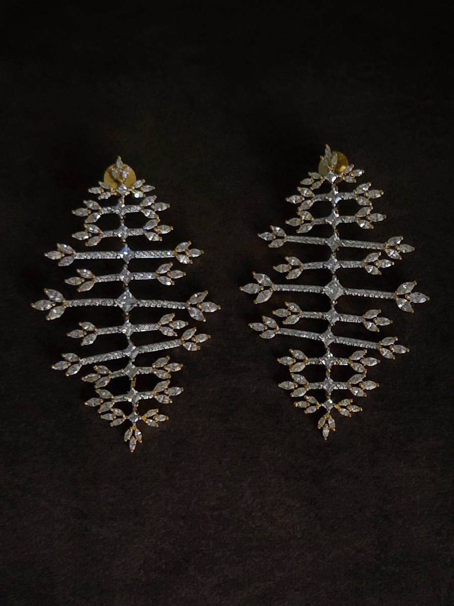 Straight horizontal zircon studded lines with three leaf design at the ends long gold finish flexible earrings