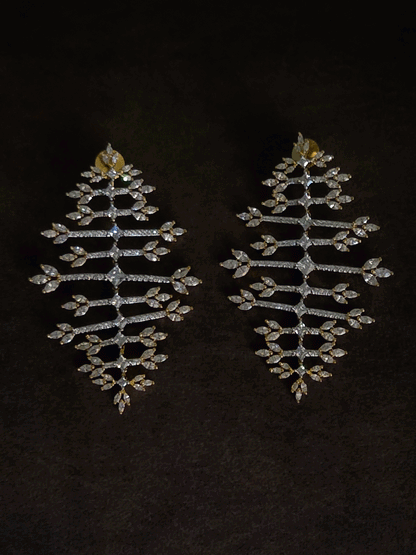 Straight horizontal zircon studded lines with three leaf design at the ends long gold finish flexible earrings