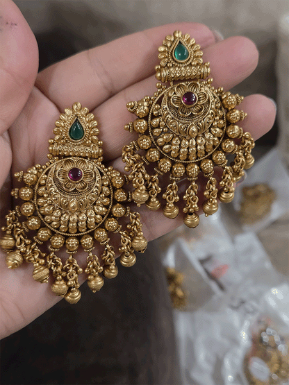 Green tear drop leaf design top with ruby stone flower and flower engraved gold bead design earrings