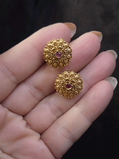 Ruby stone in the center of flower design studs with leaf petal design