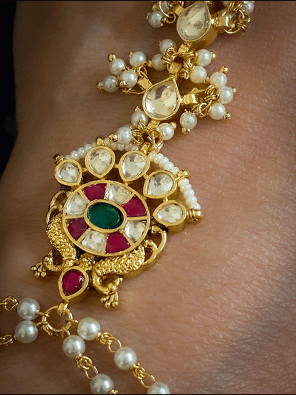 Green stone paachi kundan ring and peacock design tukdi with leaf shaped pearly hanging chain haathphool(single)