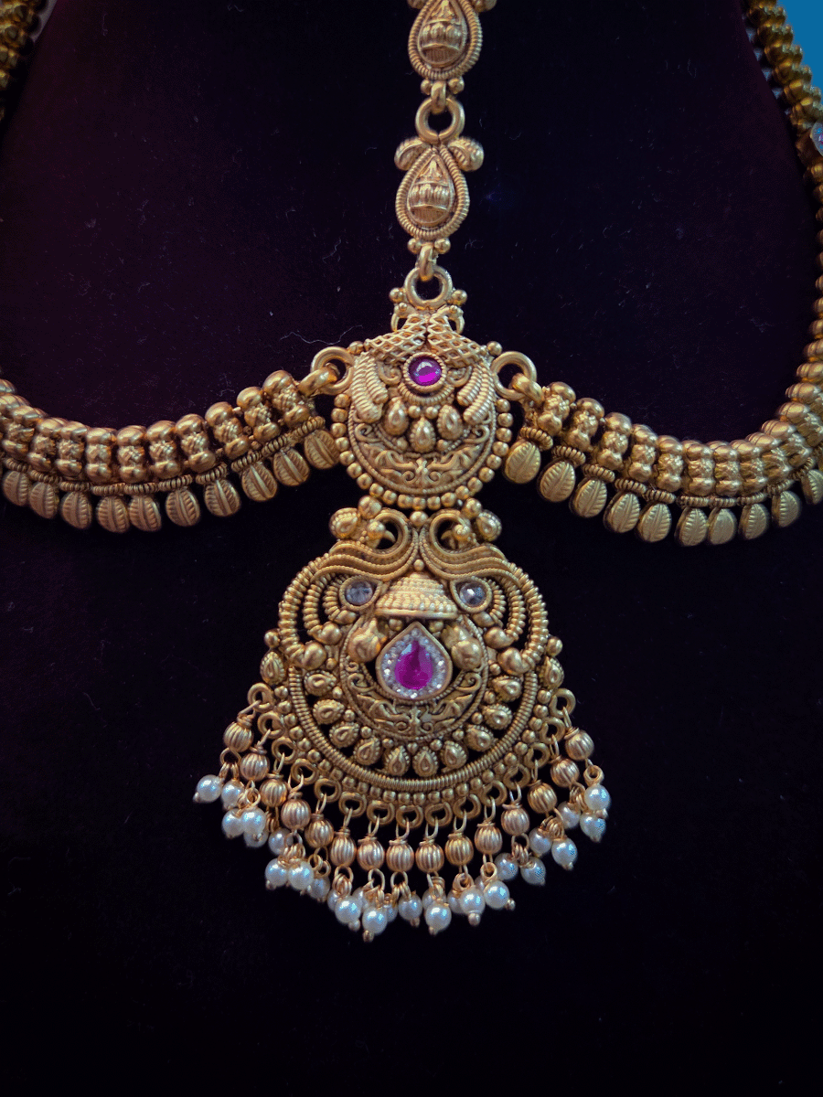 Peacock top with polki and ruby stone center tika mathapatti with leaf design side chains