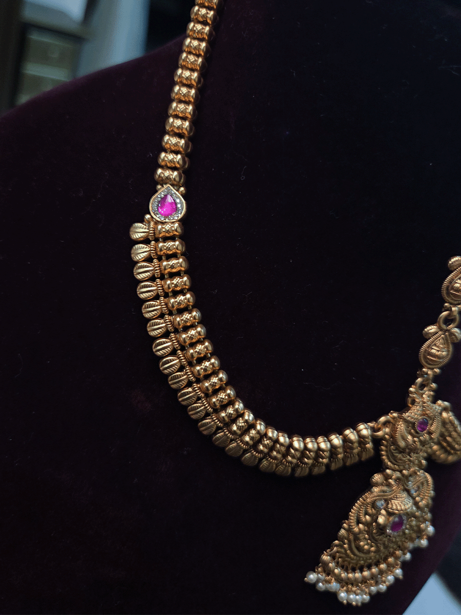 Peacock top with polki and ruby stone center tika mathapatti with leaf design side chains