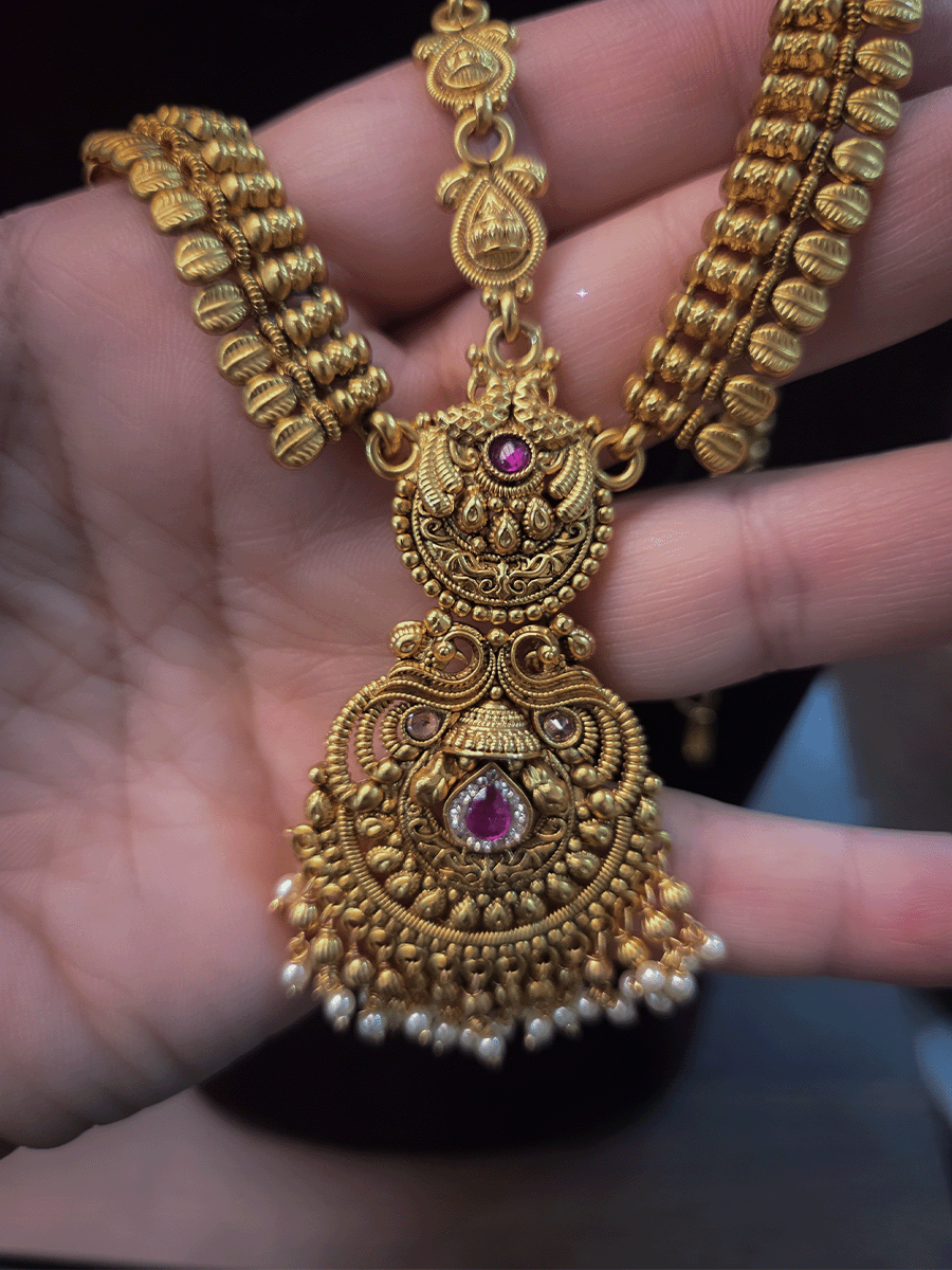 Peacock top with polki and ruby stone center tika mathapatti with leaf design side chains