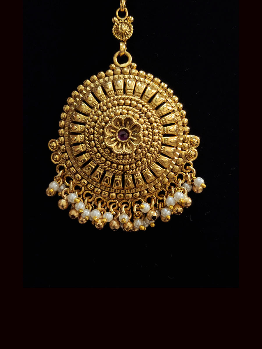 Circular maangtika with flower design center with pearl and gold bead hangings