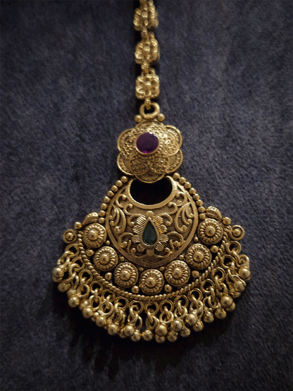 Circular self with gold bead design flower top maangtika with coloured stones