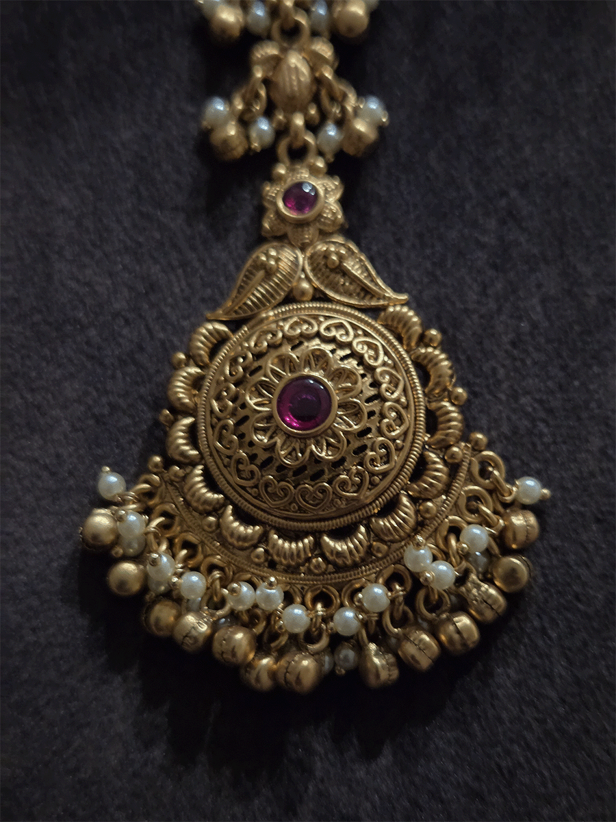 Flower and paisley top with circular flower with ruby stone maangtika