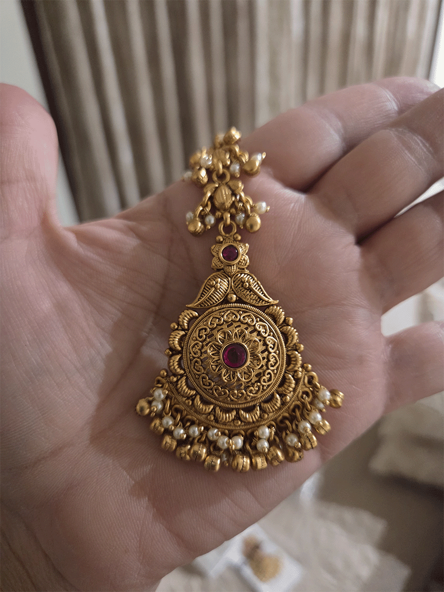 Flower and paisley top with circular flower with ruby stone maangtika