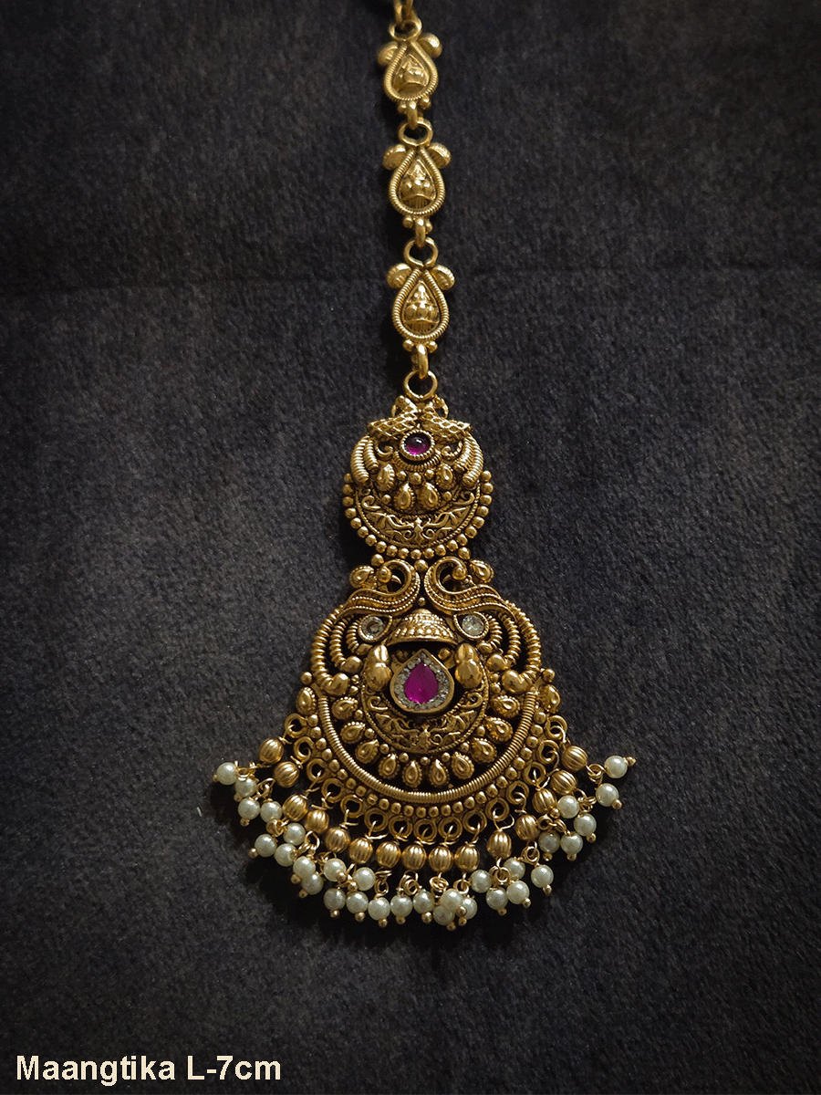 Peacock top circular design with tear drop shaped ruby stone in center of bottom design maangtika