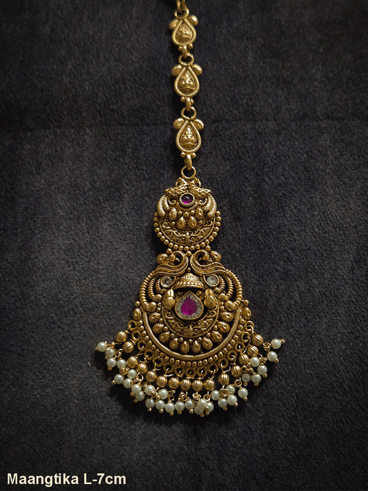 Peacock top circular design with tear drop shaped ruby stone in center of bottom design maangtika