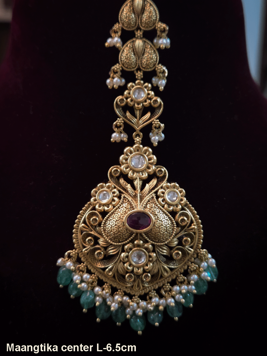 Oval ruby stone kundan studded maangtika with green bead hangings