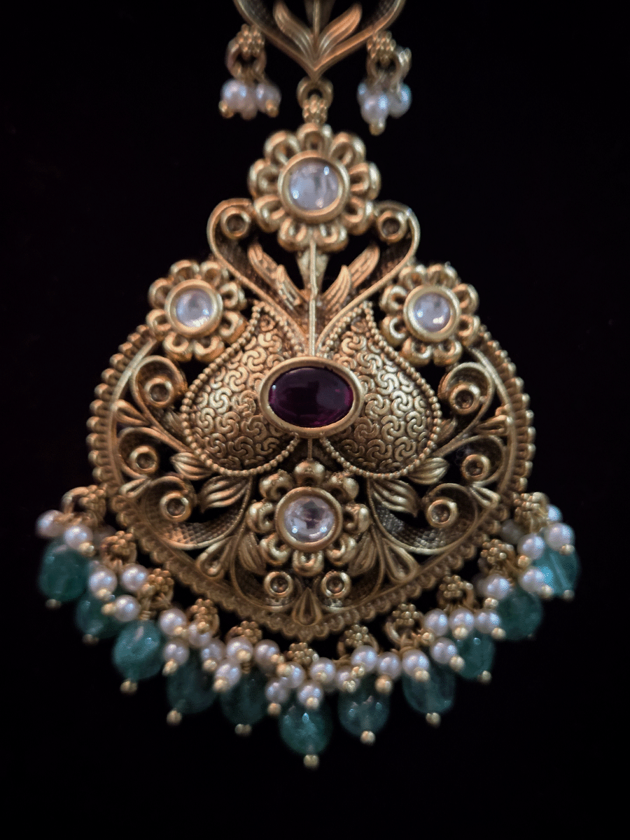 Oval ruby stone kundan studded maangtika with green bead hangings