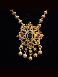 Ruby and green stones studded pendant set in gold bead chain