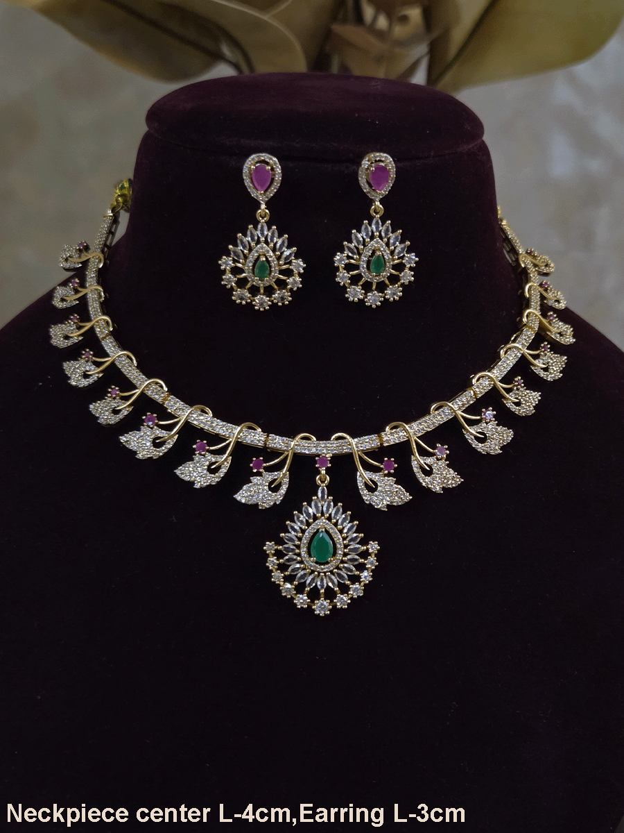 Zircon studded leaf design set with tear drop shaped green stone center hanging tukdi
