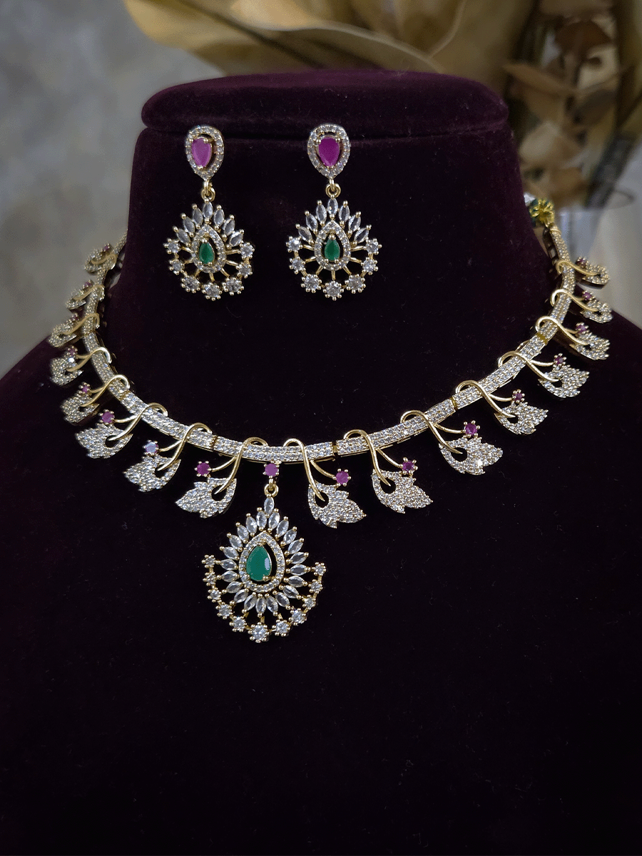 Zircon studded leaf design set with tear drop shaped green stone center hanging tukdi