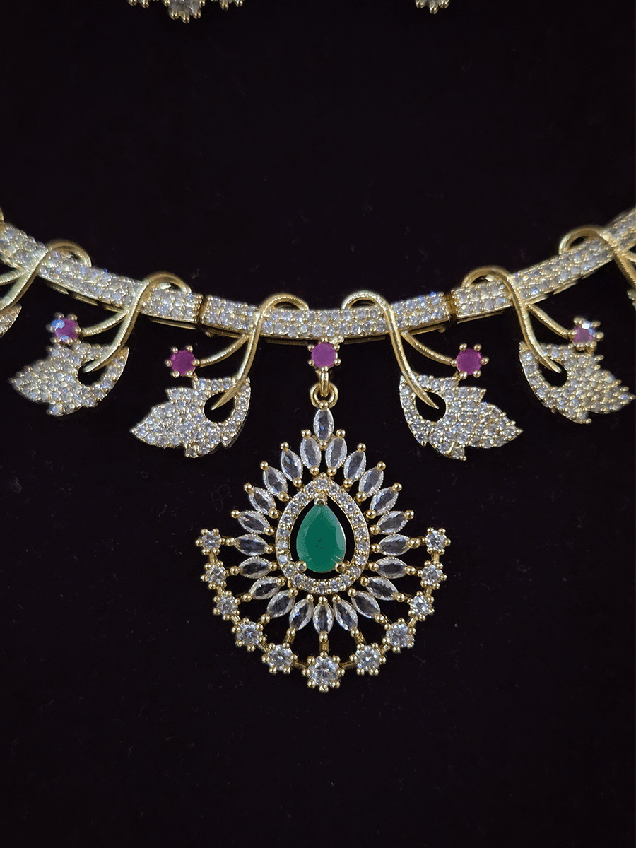 Zircon studded leaf design set with tear drop shaped green stone center hanging tukdi